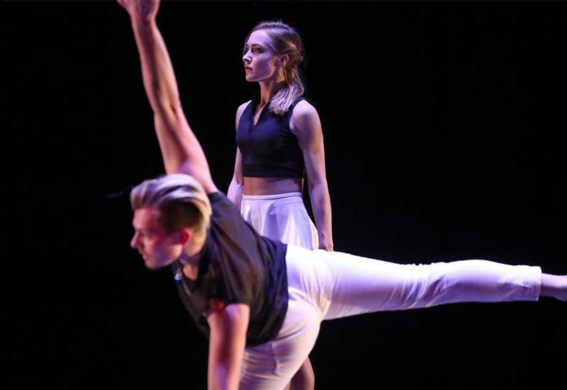 two students dance onstage