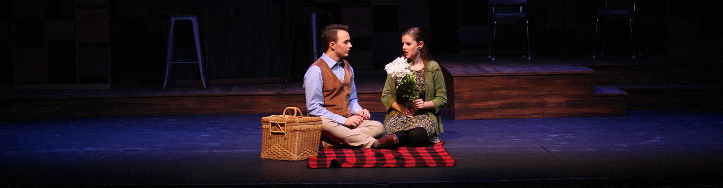 Students performing in a theatre show Rashomon